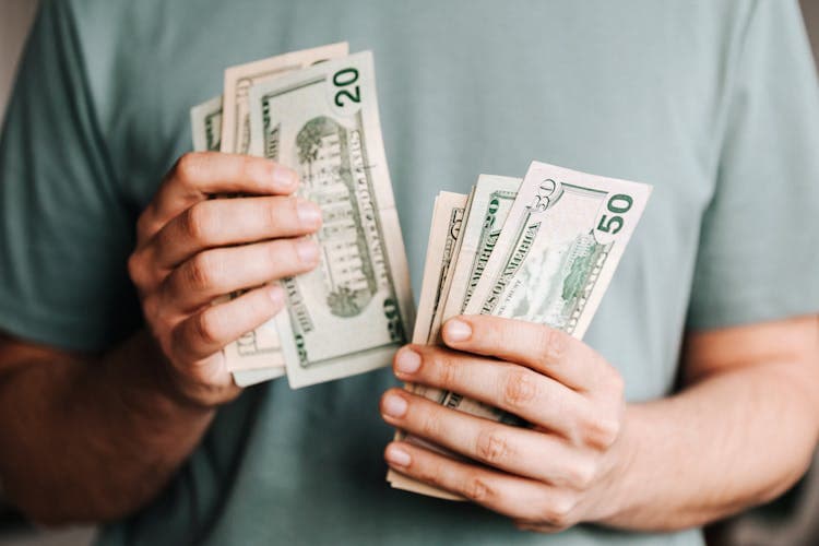 Counting out cash to split travel costs fairly between friends